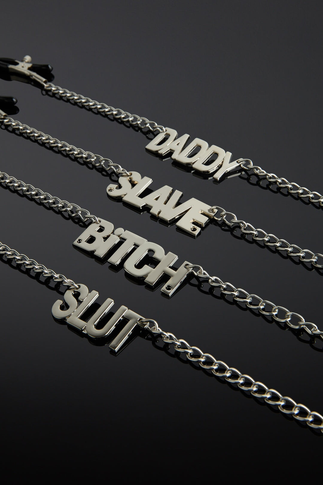 Silver chain necklaces for nipples with text on a black background