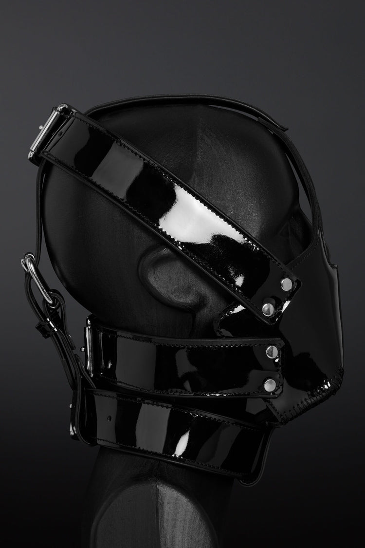 Black glossy mask with straps on a dark background