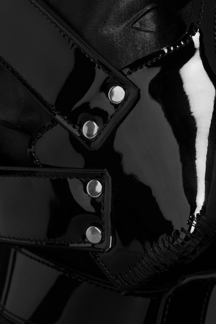 Close-up of a black leather mask with silver rivets