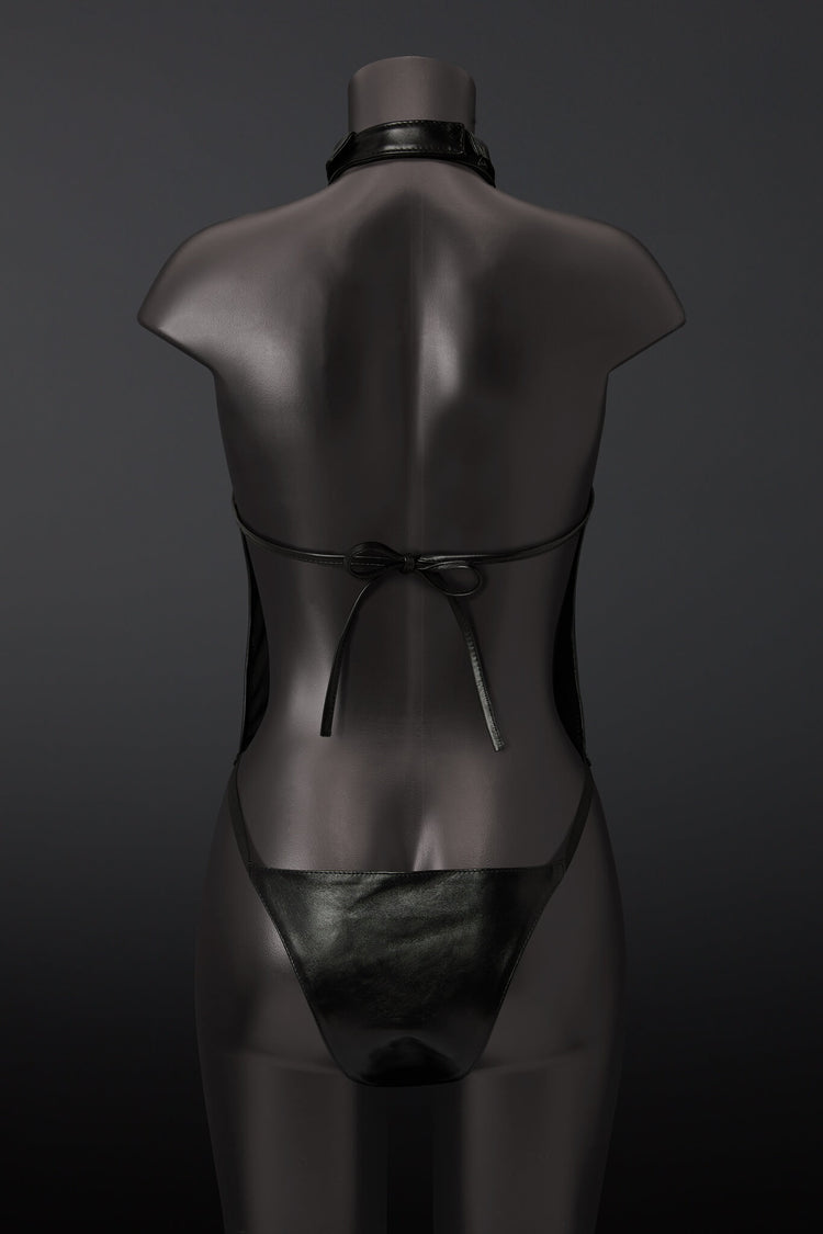 Black leather outfit on a mannequin against a dark background