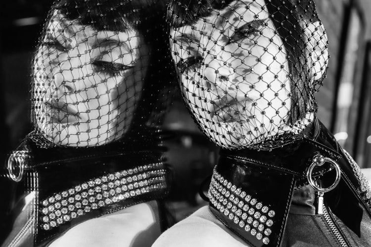 Woman wearing the Crystalla Collar with a reflection of her face in a mirror
