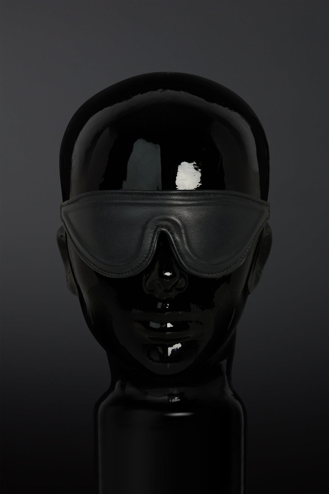 Black blindfold on a dark background