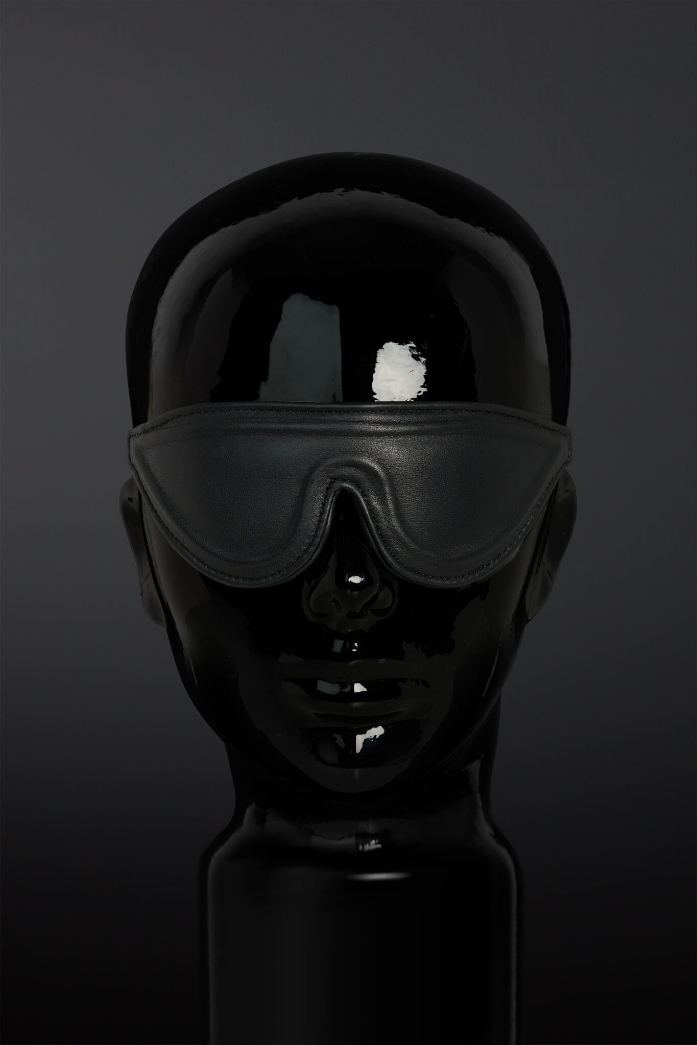 Black blindfold on a dark background