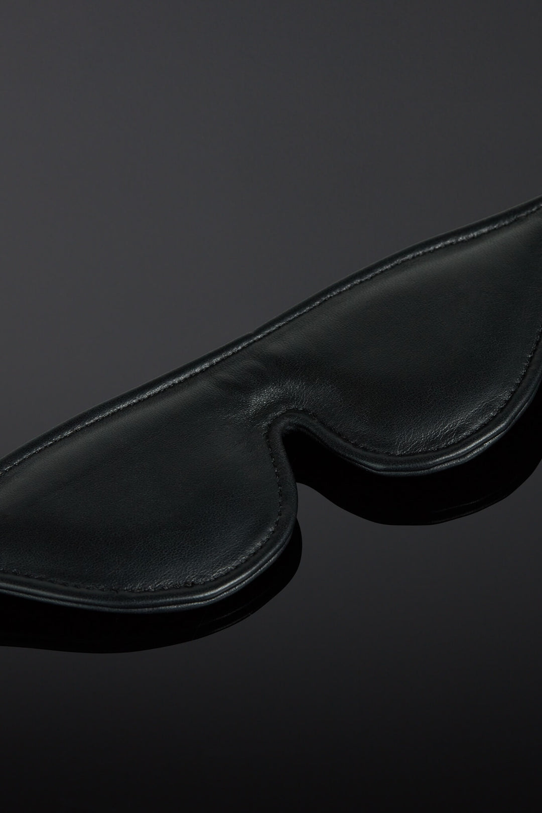 Black blindfold on a dark background