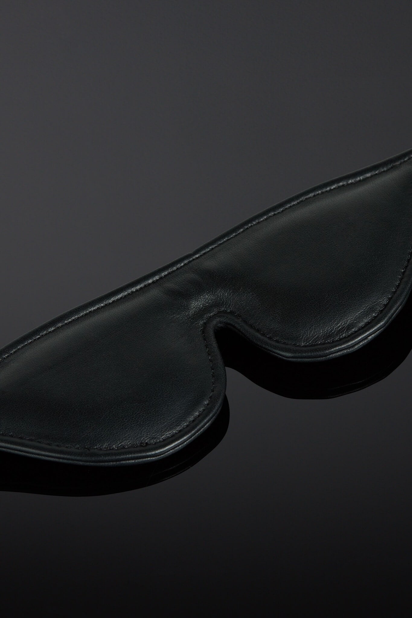 Black blindfold on a dark background