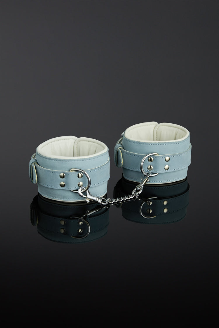 sea green color wrist cuffs on a black background