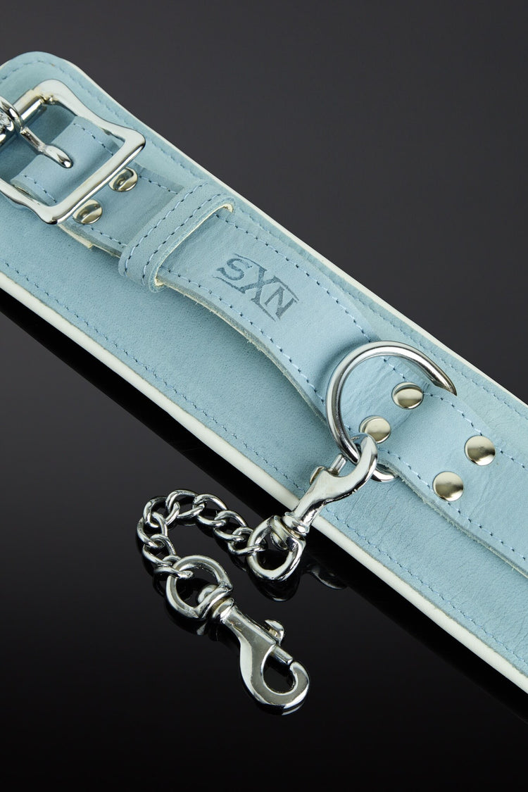 sea green color wrist cuffs on a black background - close up shot of buckles