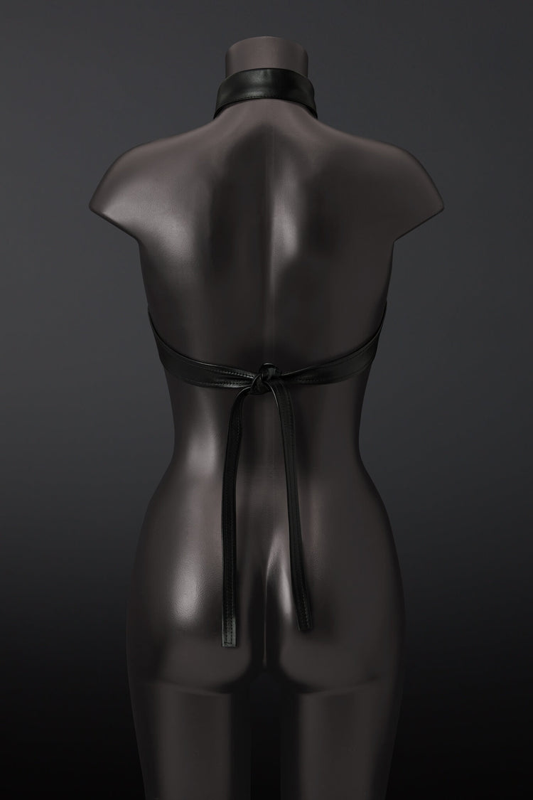 Black leather outfit on a mannequin against a dark background