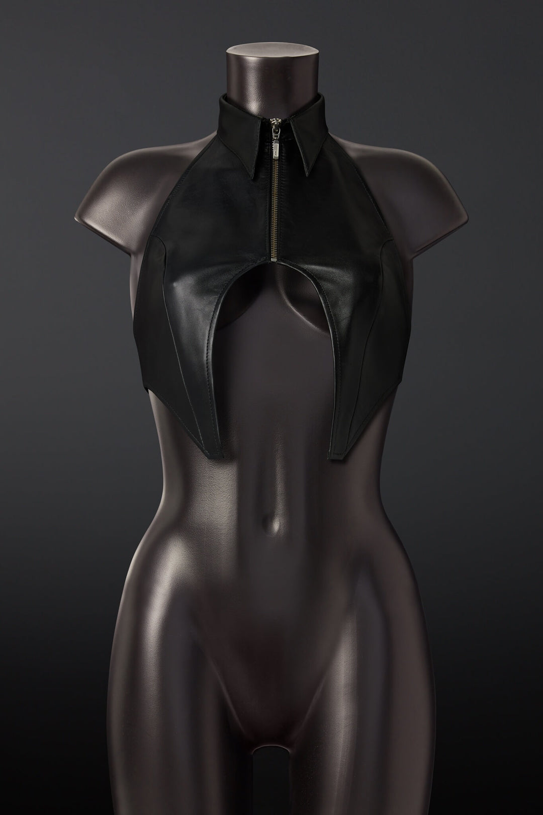 Black leather outfit on a mannequin against a dark background