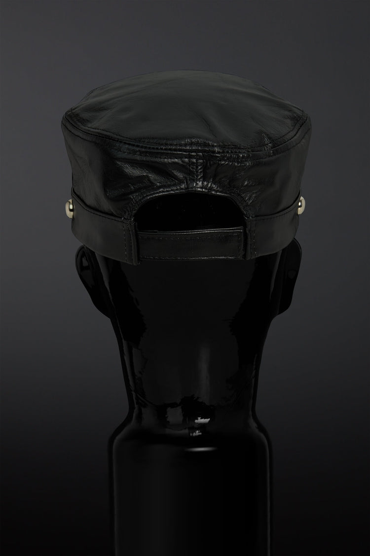 Black cap on a black mannequin head against a dark background