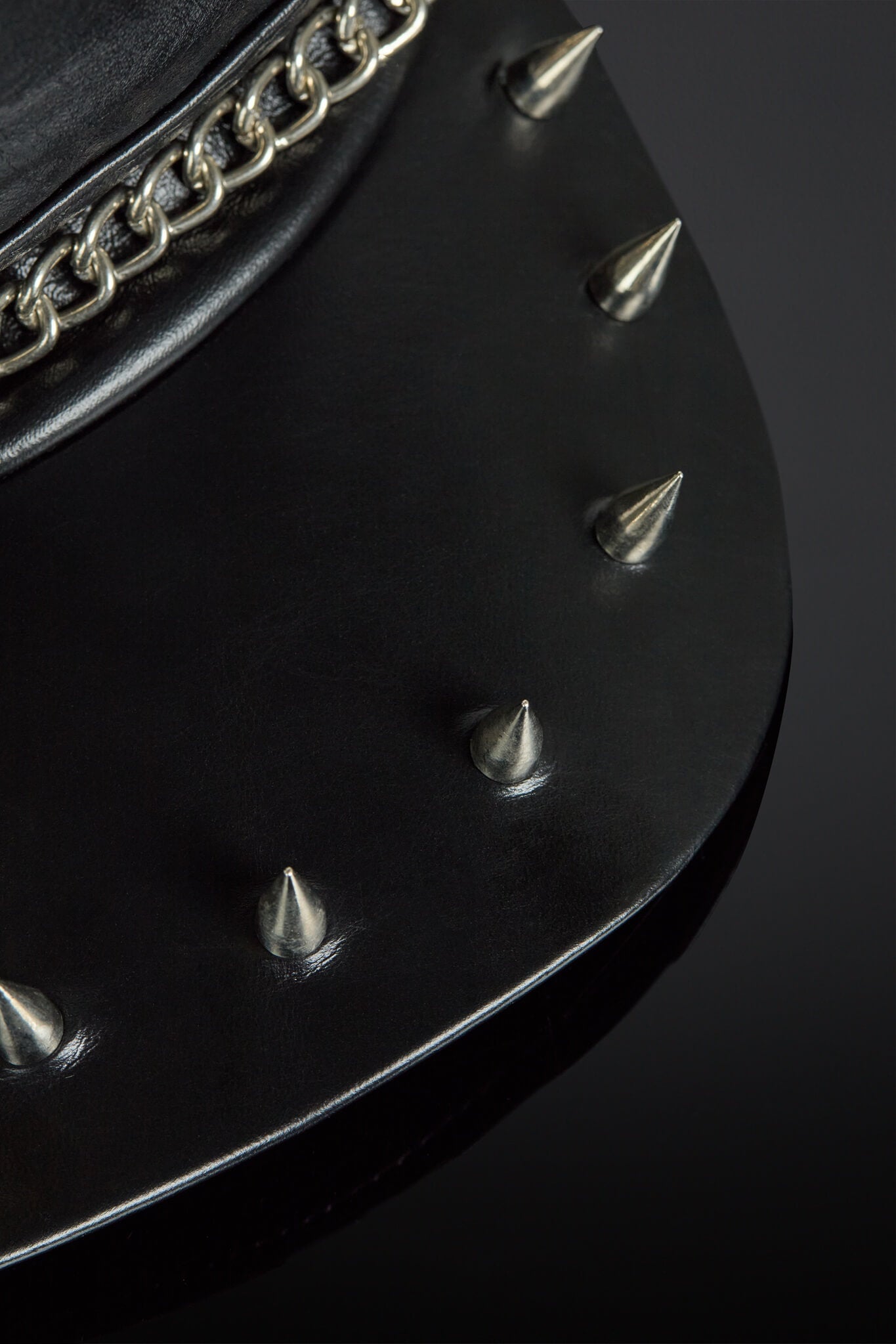 close up of metal spikes on a leather brim