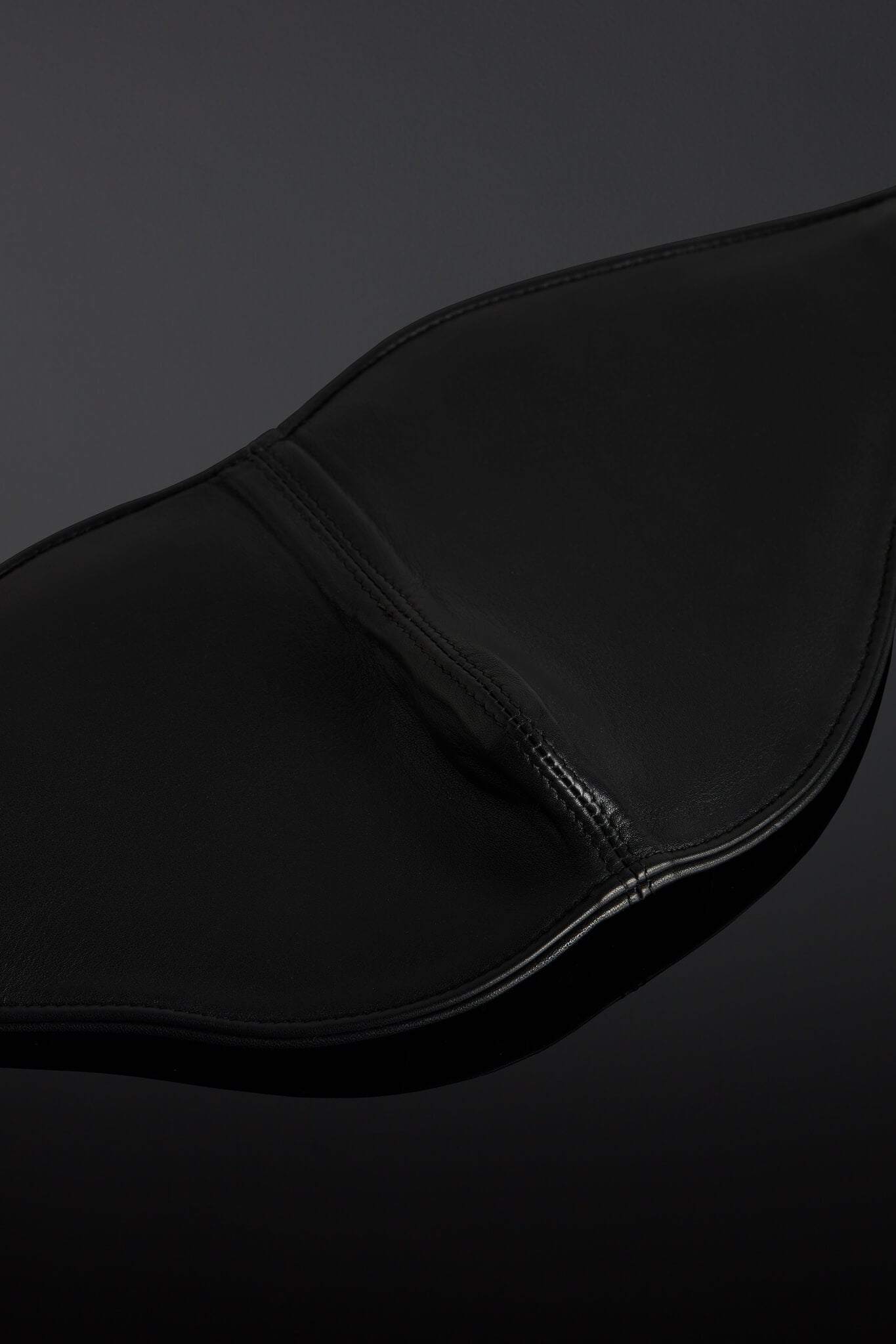Black leather blindfold on a dark background