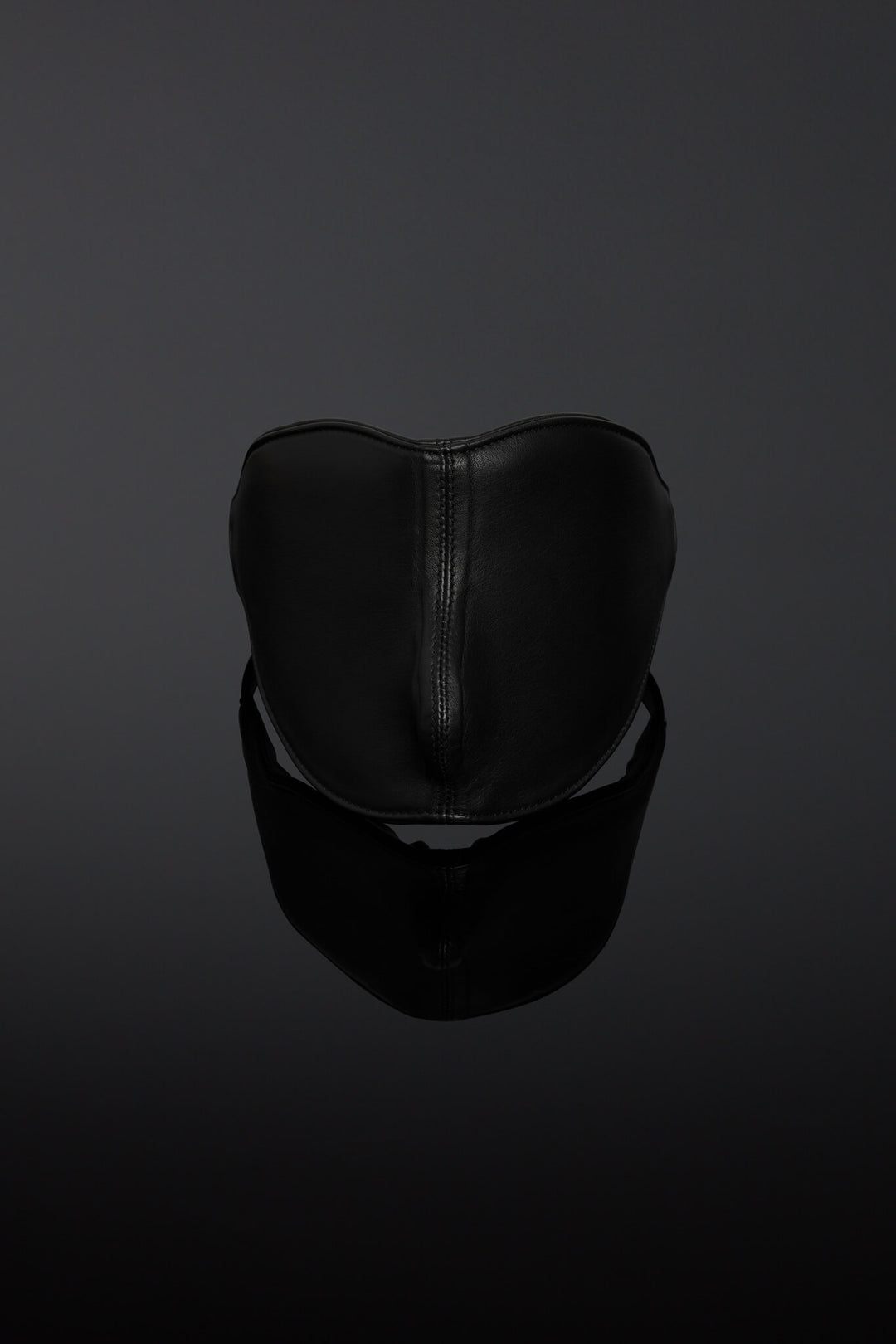 Black leather blindfold on a dark background