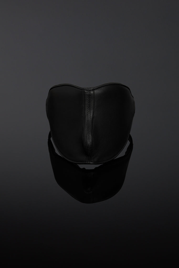 Black leather blindfold on a dark background