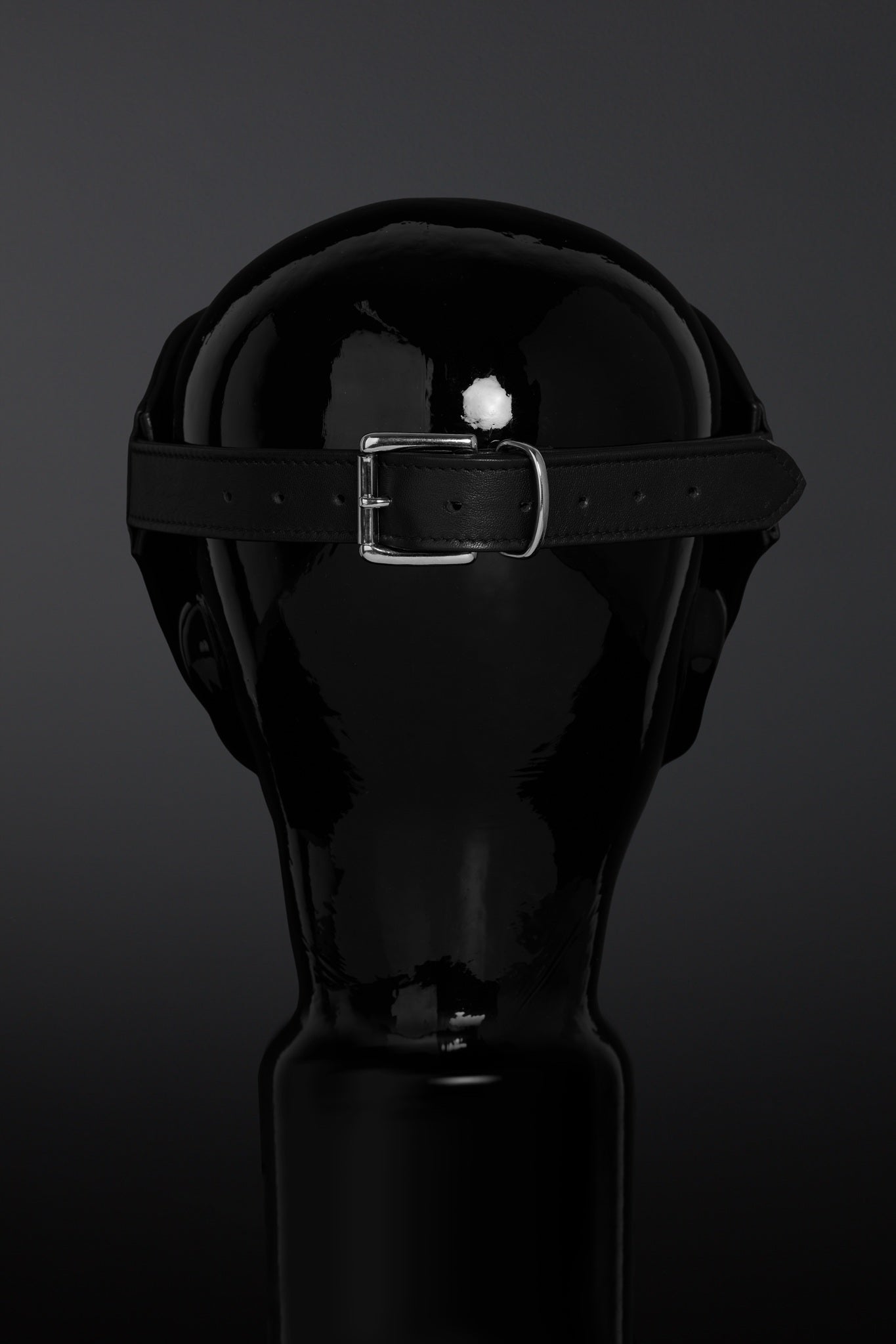 Black leather blindfold on a dark background
