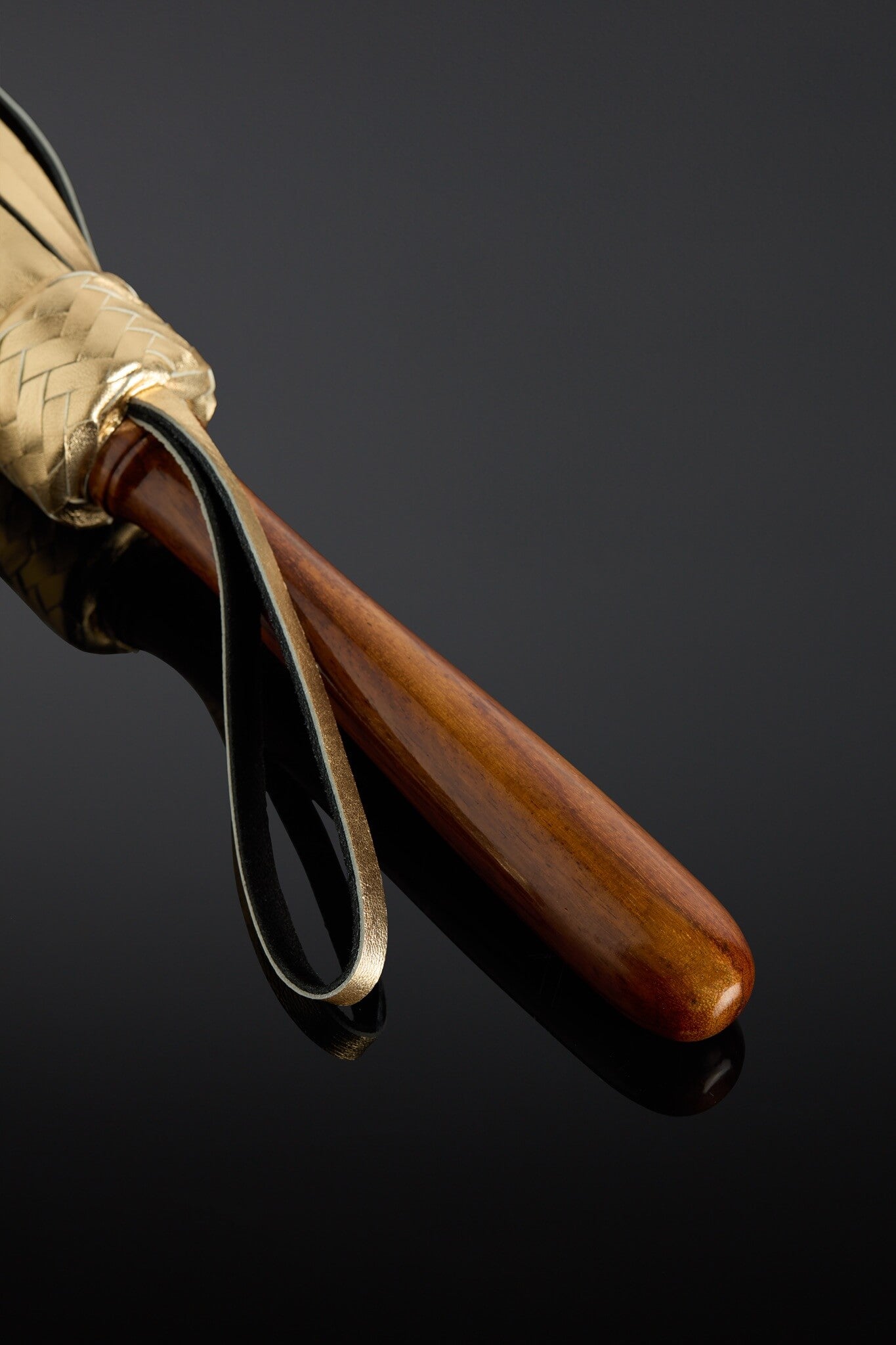 Close-up of a wooden handle on a dark background
