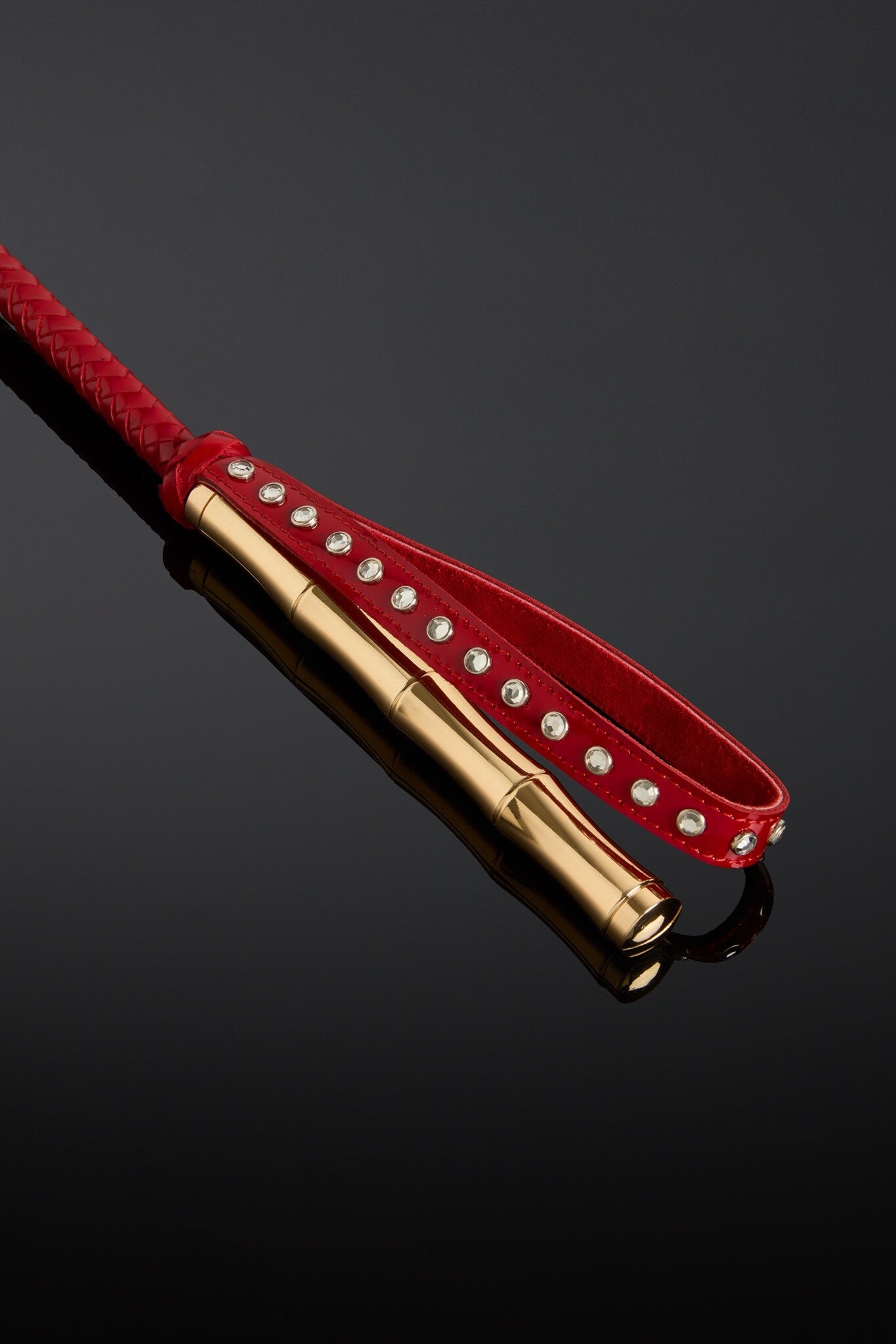 Closeup photo of bamboo shaped metal handle in gold color on black background