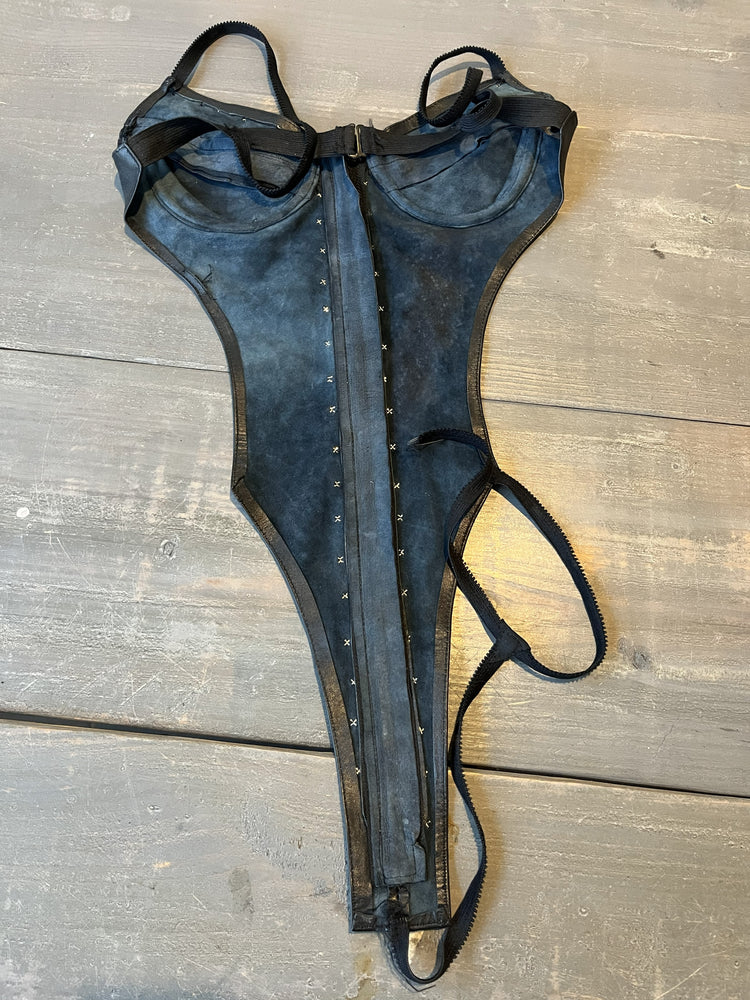Reverse interior suede side of leather lingerie sitting on table