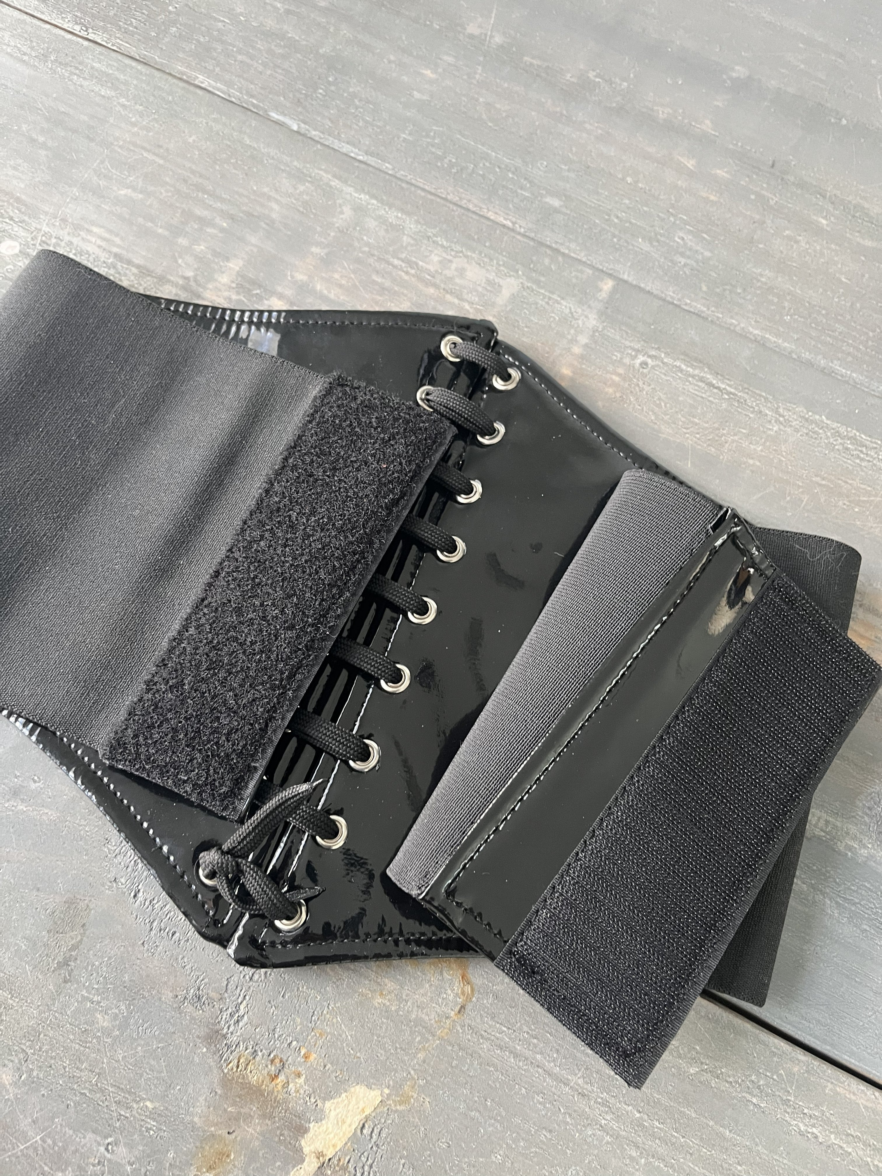 back side of leather corset laying on table