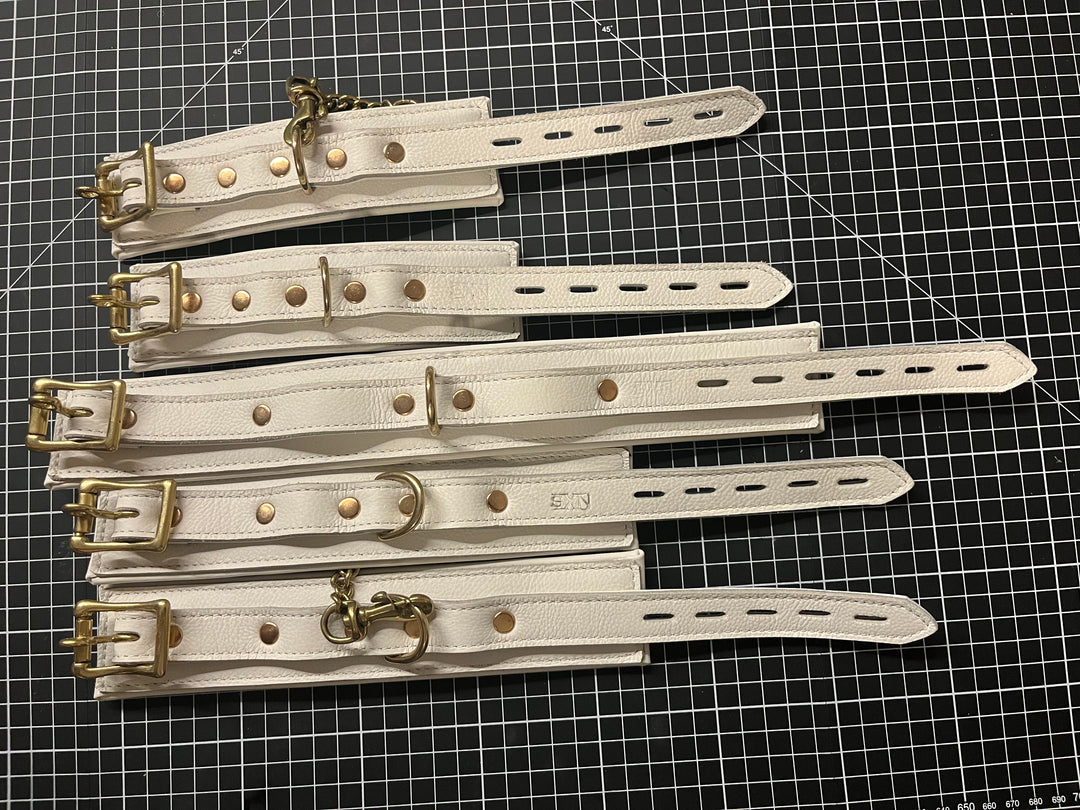 White leather padded cuff set, size small - Sample