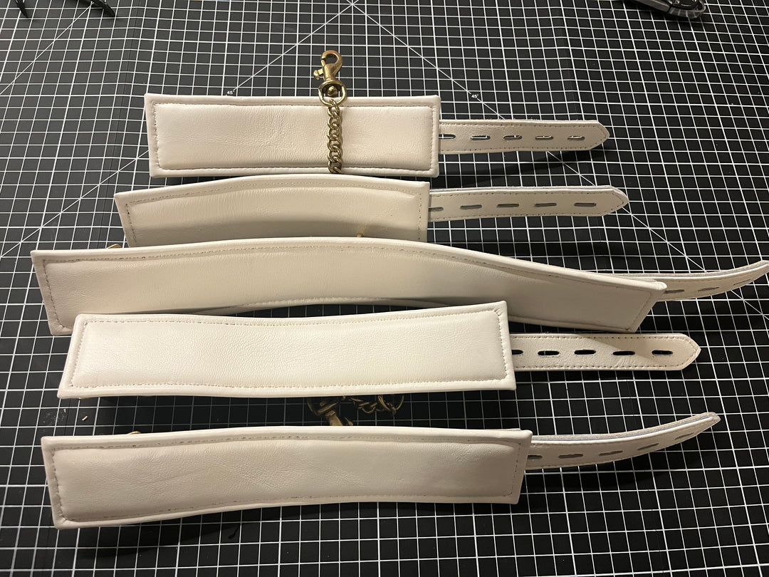 White leather padded cuff set, size small - Sample