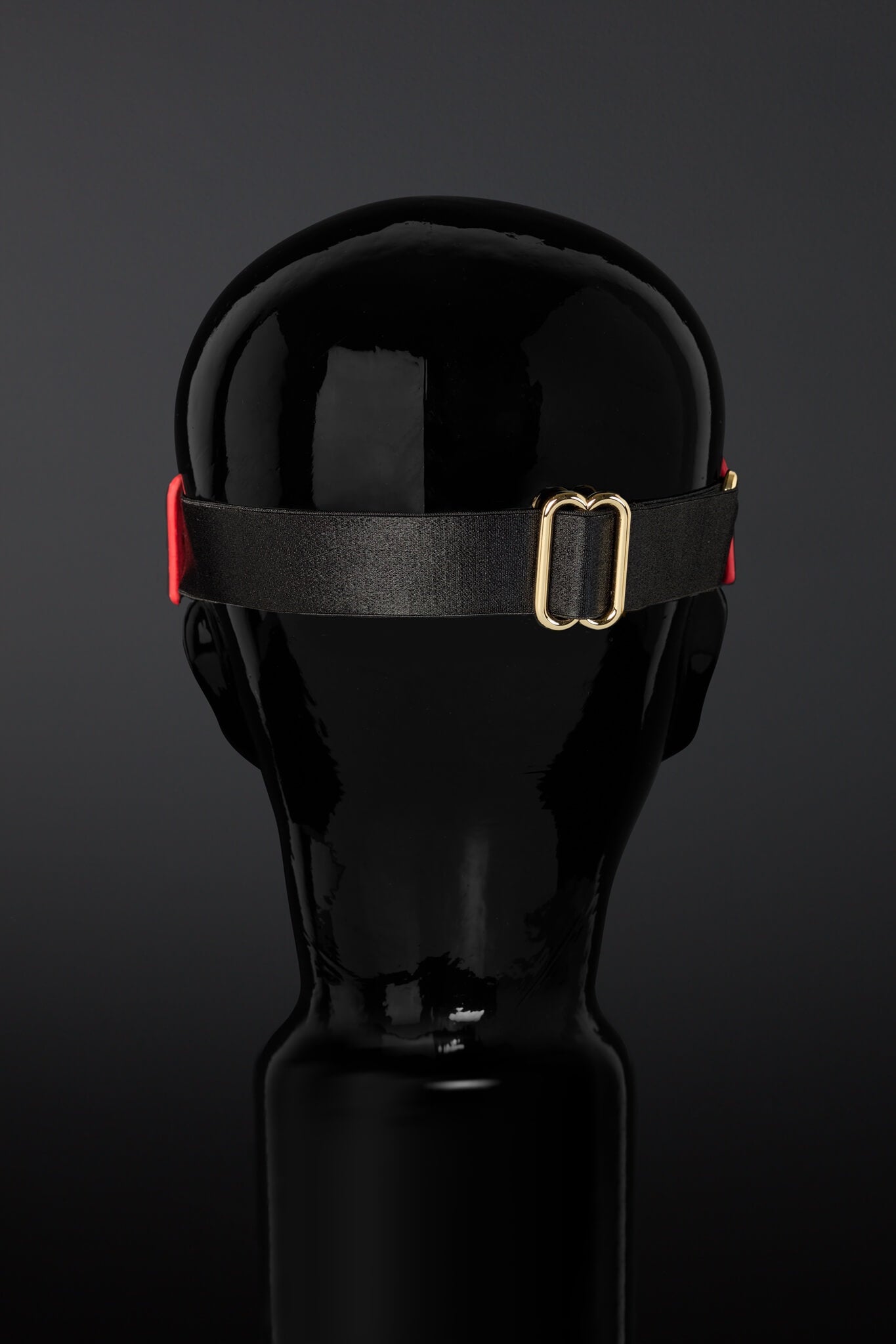 Photo of mask strap on back of mannequin 