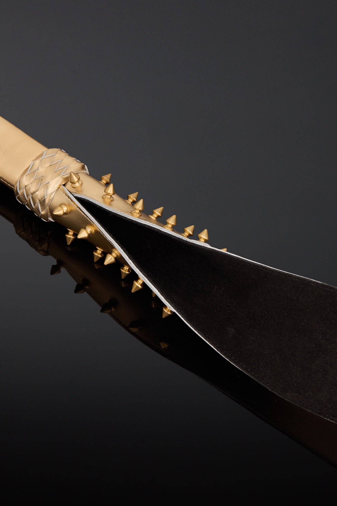A close-up studio shot of black suede leather on the under side of the tail. 