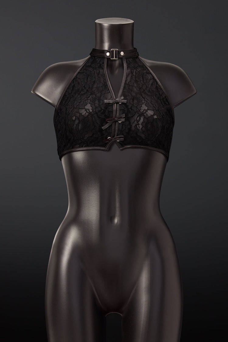 Black lace halter bralette with matching black choker collar and front lace-up closure, displayed on a glossy black mannequin torso against a dark gray background.