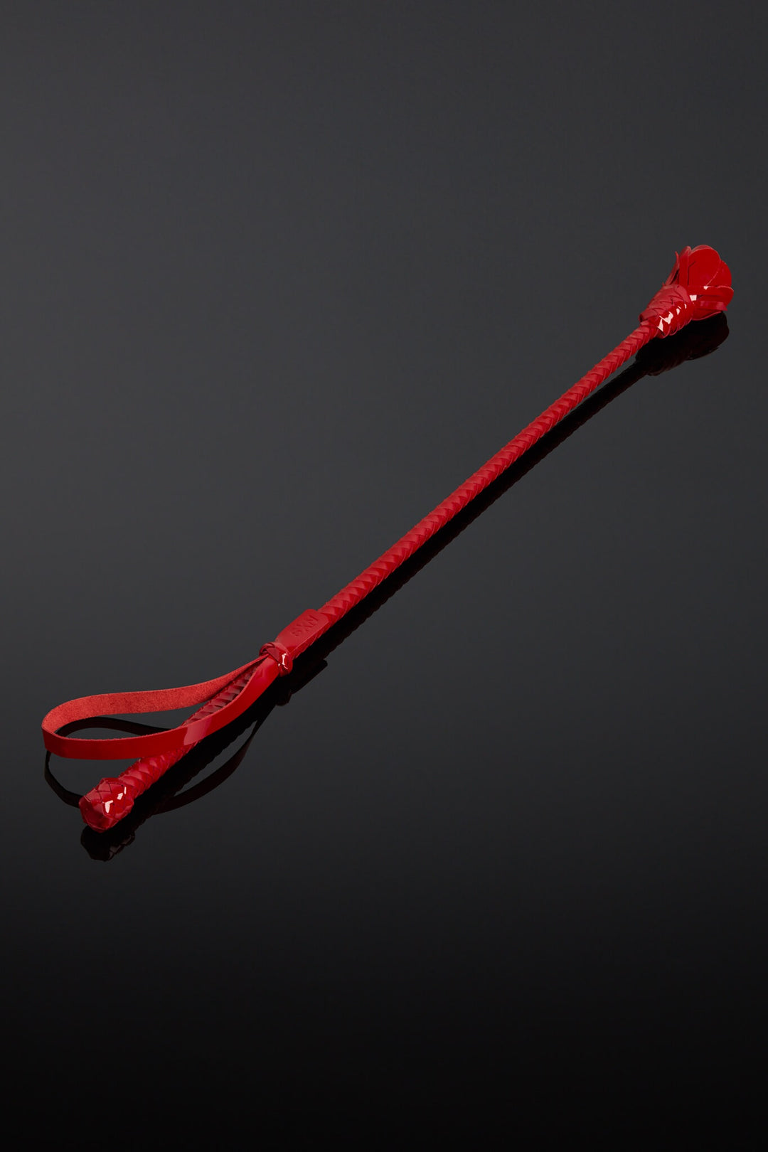 Red plastic tool on a black background
