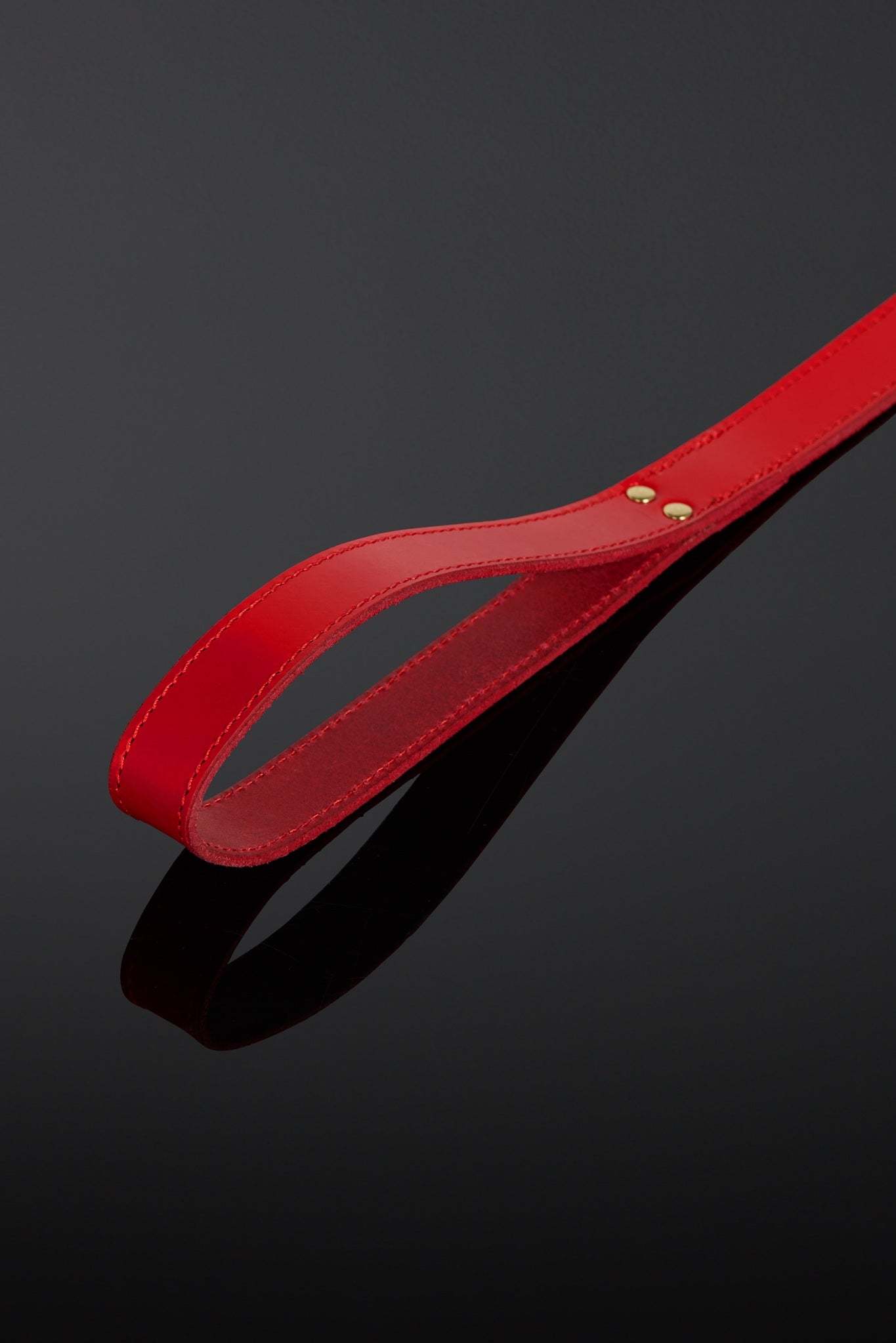 Red leather belt on a black background