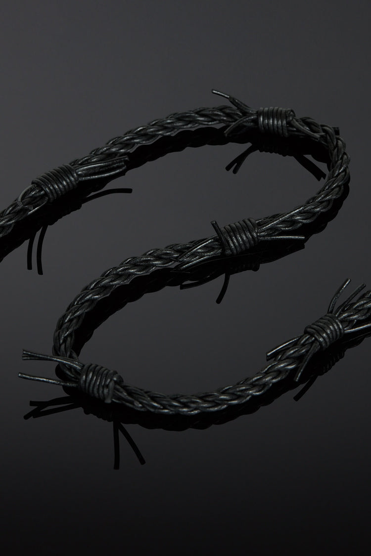 Barbed wire design on a black background