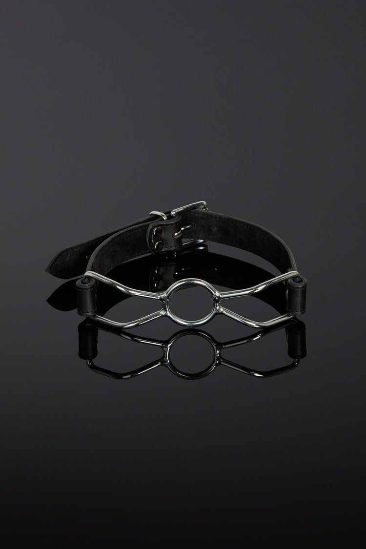Black leather choker with metal accents on a dark background