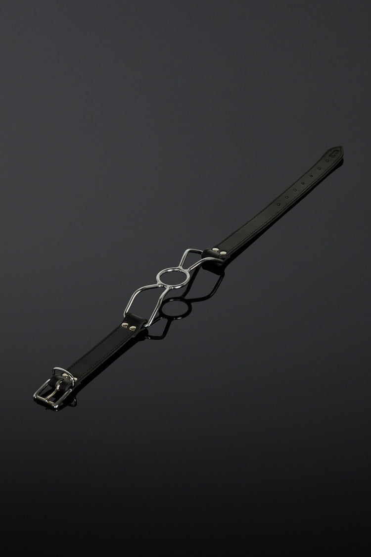 Black leather belt with silver buckle on a dark background